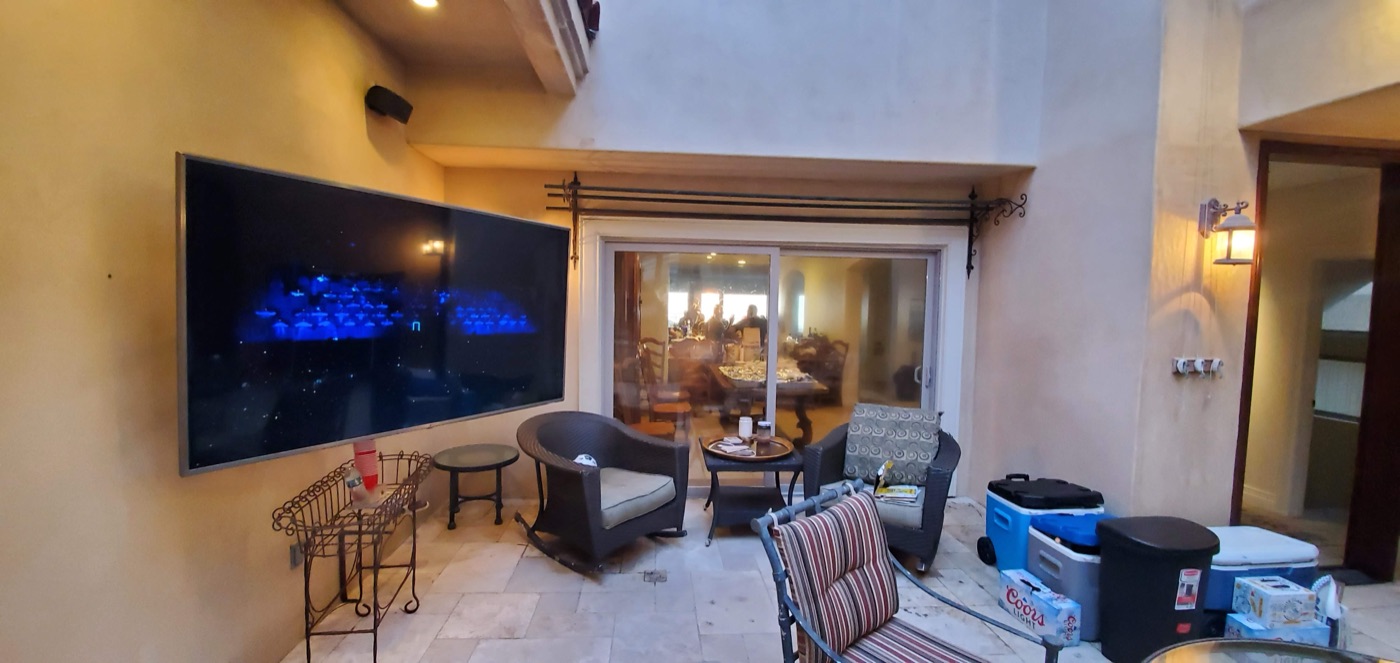 TV mounted outdoors in a stucco fireplace alcove under a covered patio in Henderson NV